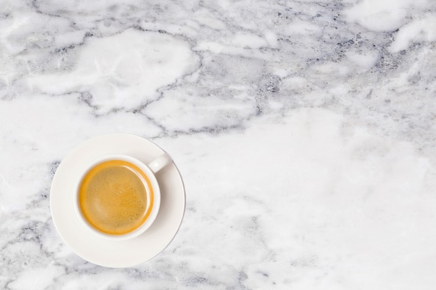 Coffee cup on marble table top view.