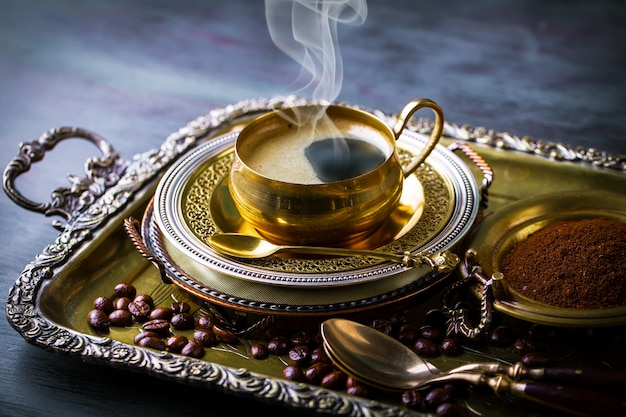 Coffee in a cup on an old table.