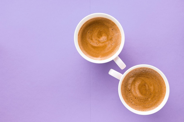 Coffee cup on purple background top view flatlay