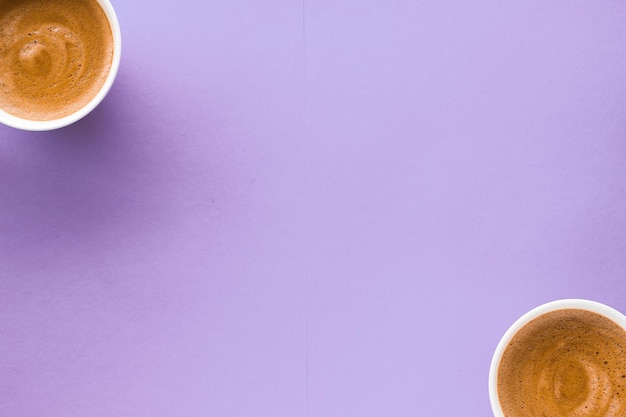 Coffee cup on purple background top view flatlay