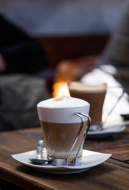 Coffee cup on a restaurant wooden table Copy space