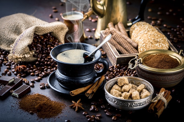 Coffee in a cup and saucer on a black background