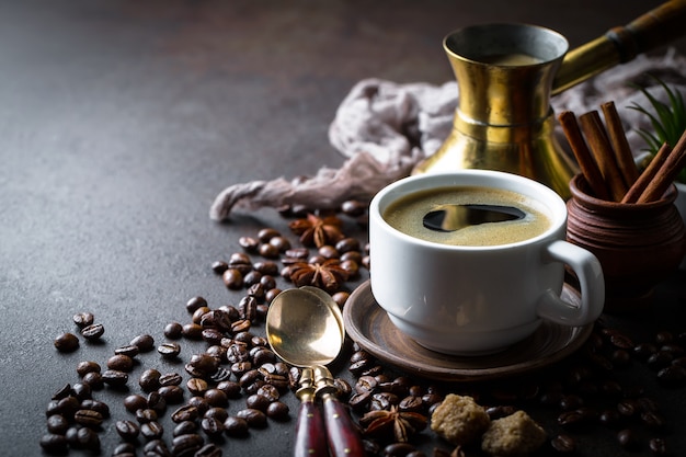 Coffee in a cup and saucer on a black background