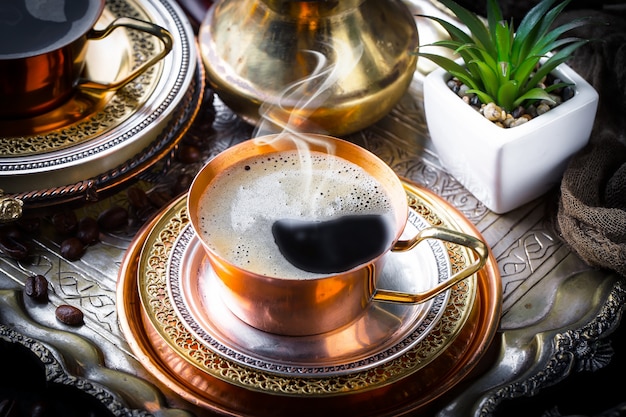 Coffee in a cup and saucer on an old background