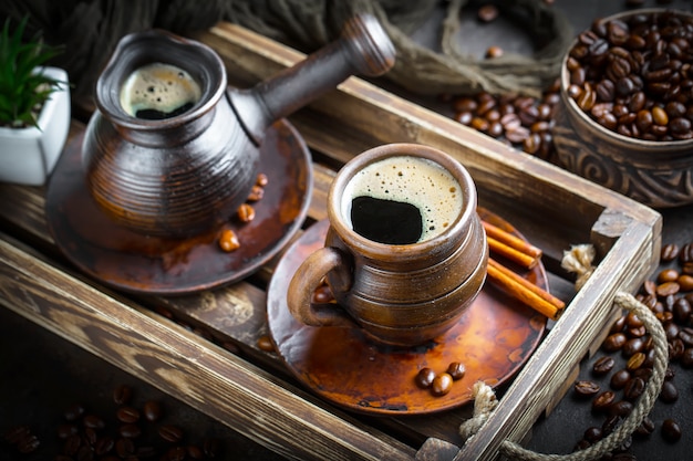 Coffee in a cup and saucer on an old background