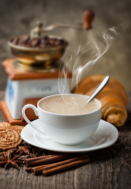 Coffee in a cup and saucer on an old space.