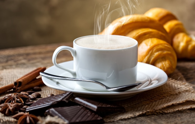 Coffee in a cup and saucer on an old space.