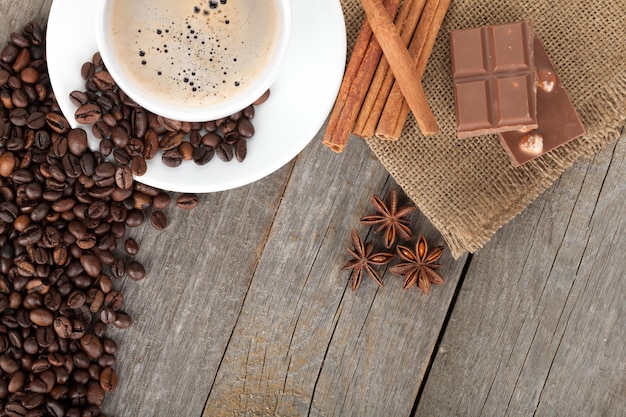 Coffee cup and spices on wooden table texture