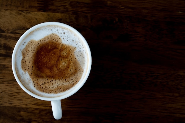 Coffee cup top view on wooden table