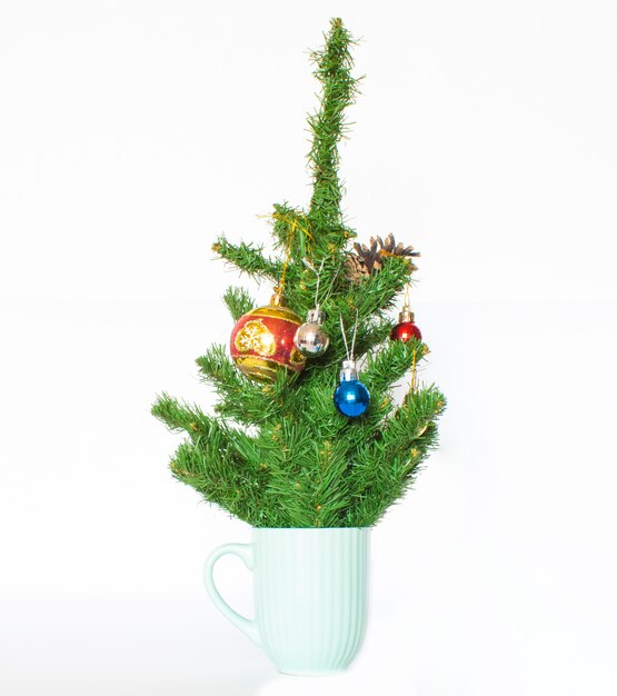 Coffee cup with Christmas tree. Minimal winter holidays concept.