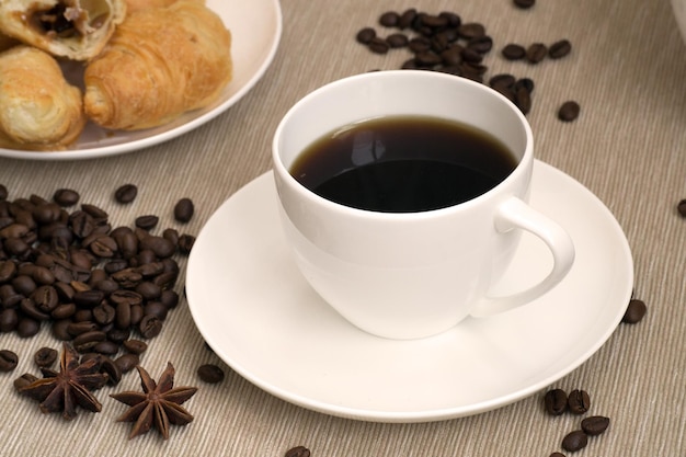 Coffee cup with croissant for breakfast