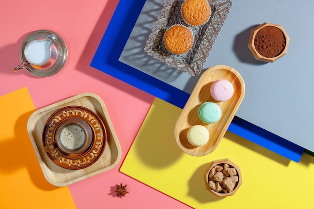 Coffee in a cup with dessert on a bright colored background