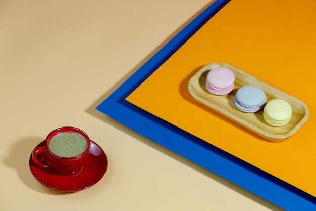 Coffee in a cup with dessert on a bright colored background