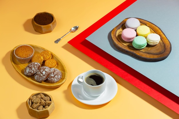 Coffee in a cup with dessert on a bright colored background