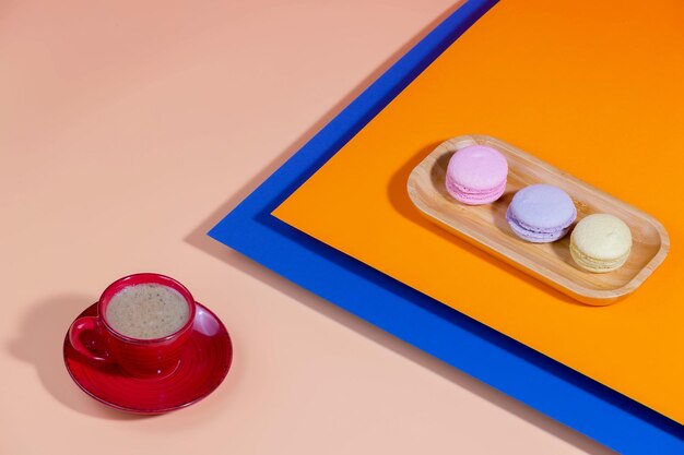 Coffee in a cup with dessert on a bright colored background