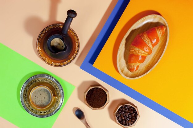 Coffee in a cup with dessert on a bright colored background