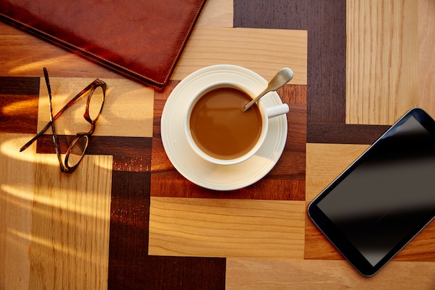 Coffee cup with glasses and tablet pc