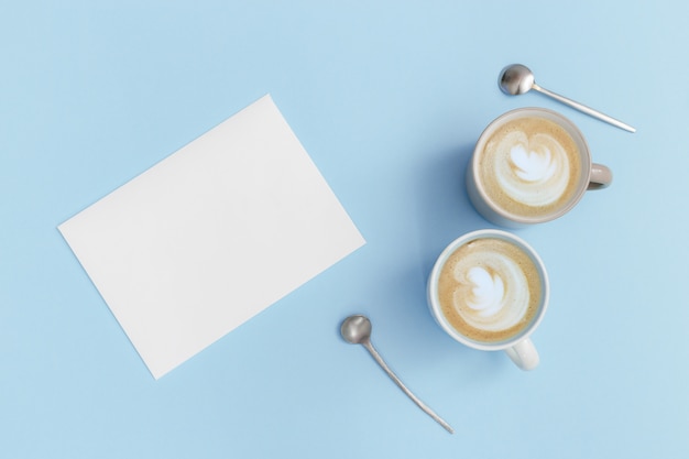 Coffee cup with latte art foam and empty sheet of paper for writing ideas or to-do list or future plans. Time for rest and reflection. Top view.