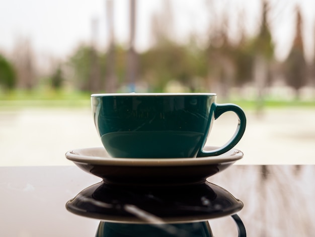 coffee Cup with reflection on a table