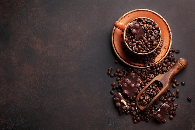 Coffee cup with roasted beans and chocolate