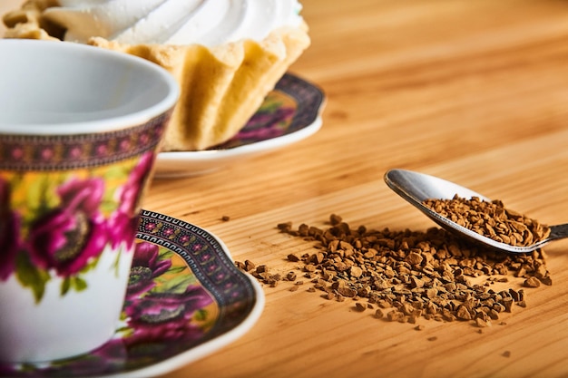 coffee cup with traditional turkish pattern and cake on brown wooden table with spoon of coffee