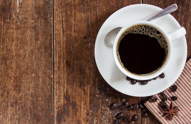 Coffee cup on wooden table background