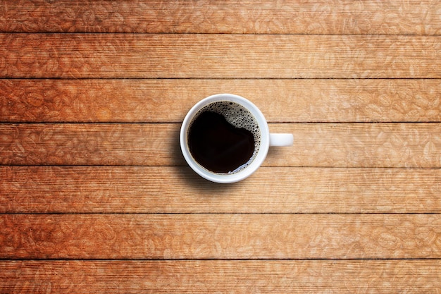 Coffee cup on wooden table top view