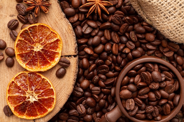 Coffee and decor of dried oranges. Clay cup with coffee beans in the lower corner of the screen