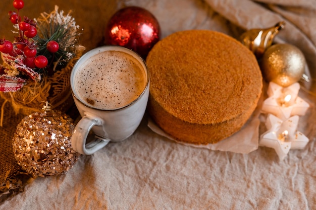 Coffee in a designer mug and homemade honey cake on a wooden table in a New Year atmosphere cozy christmas cozy winter