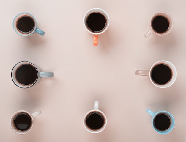 Coffee in the different cups on the gray background