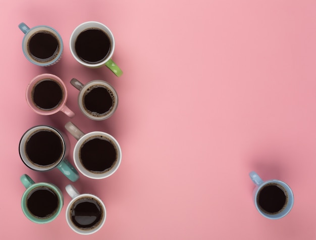 Coffee in the different cups on the pink background. Flatlay, cheerful day concept