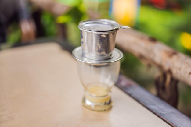 Coffee dripping in vietnamese style on wooden table