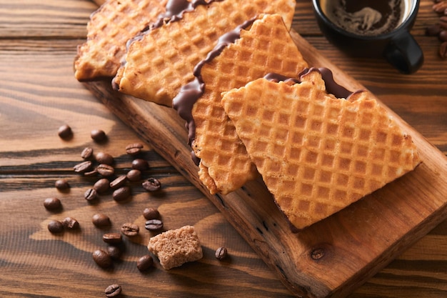 Coffee and dutch waffles Espresso coffee and dutch waffles or syrupwaffles cookies with chocolate on old wooden table Perfect syrupwaffles cookies for Breakfast Top view Mock up