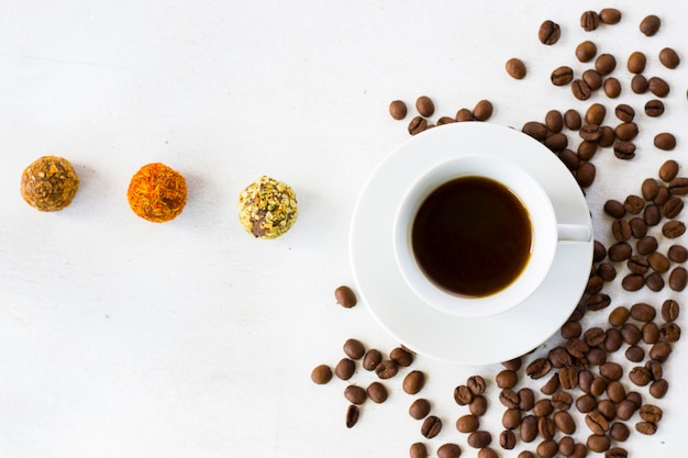 Coffee espresso and truffles balls on the plate, coffee and dessert