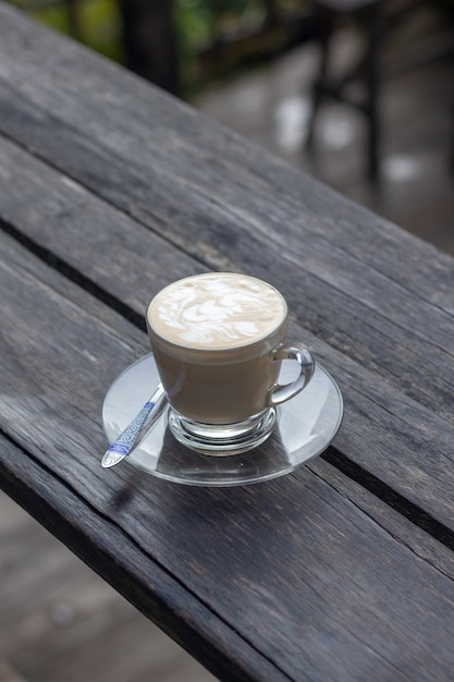 Coffee espresso on wood table nature background in garden