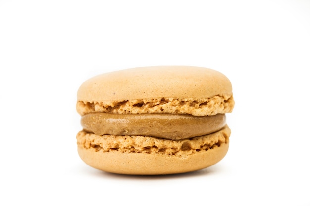 Coffee flavored macaron isolated on a white