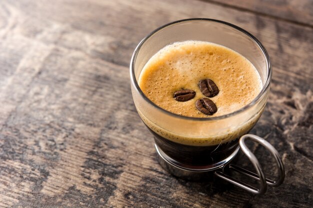 coffee glass and coffee grain on wooden table