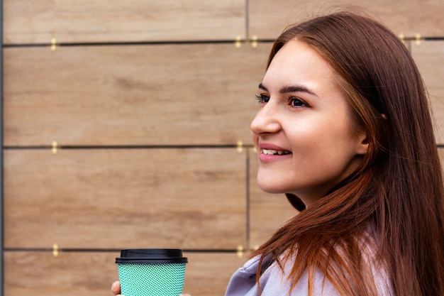 Coffee to go concept young woman portrait