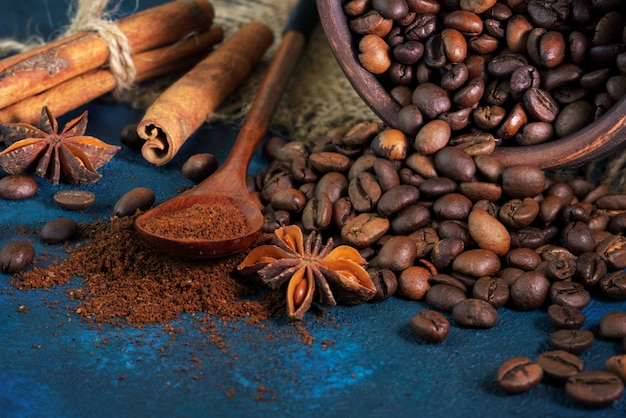 Coffee grains scattered on a blue texture