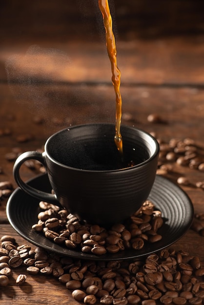 Coffee hot and Black Cup pouring coffee into a black cup on rustic wood dark food style photo selective focus