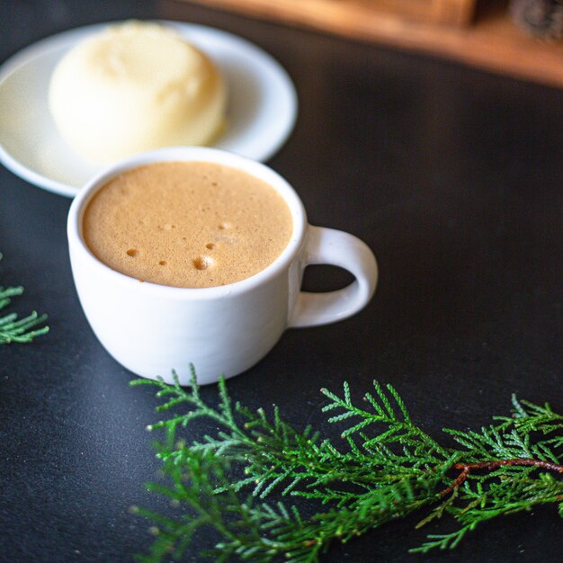 coffee hot drink in white cup spruce branches