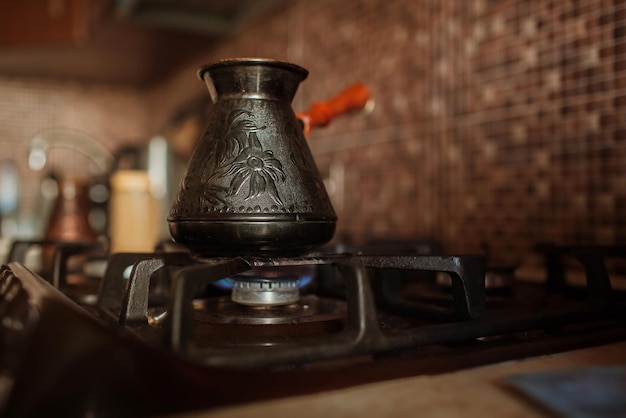 coffee is brewed on the stove in jezve