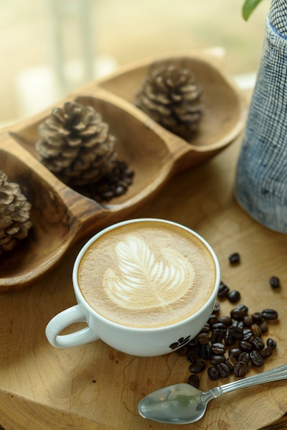 Coffee latte art on wooden table.