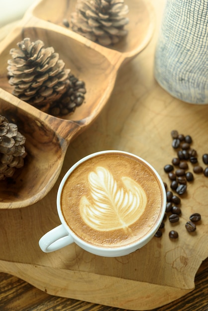 Coffee latte art on wooden table.