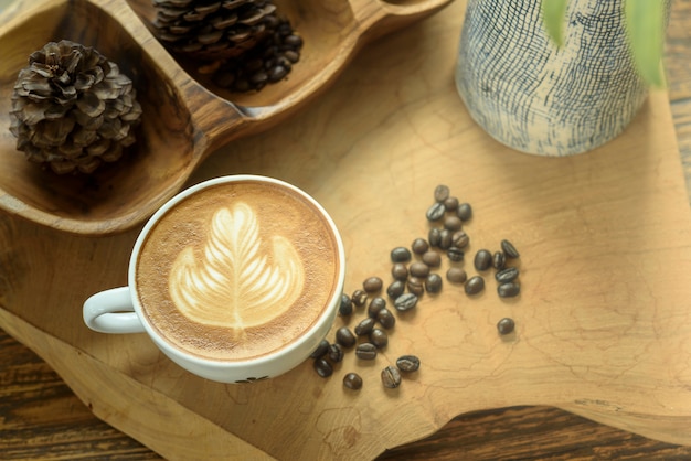 Coffee latte art on wooden table.