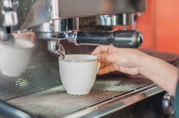 Coffee machine of hold pouring espresso into cup