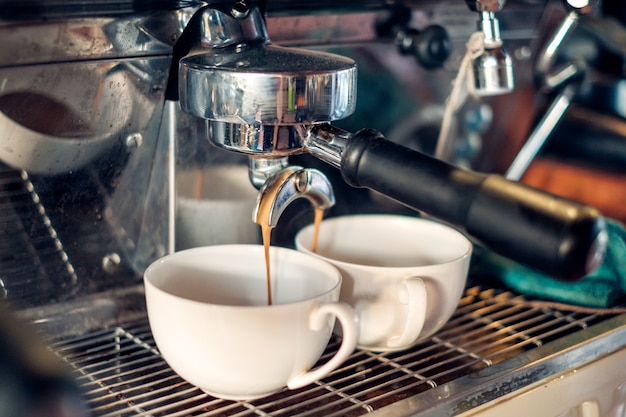 Coffee Maker making coffee flowing in cup