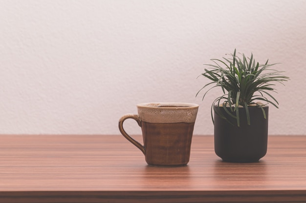 The coffee mug is on the table. The concept of drinking coffee.