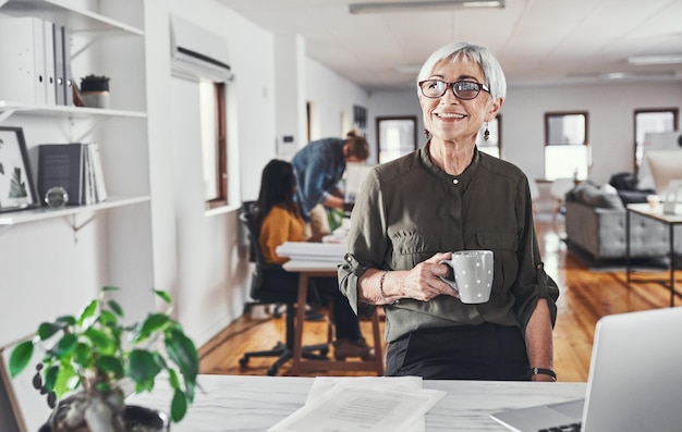 Photo coffee portrait and woman with smile in office for creative job confidence and start of work day business mature employee and happy with drink for administration career and beverage at startup