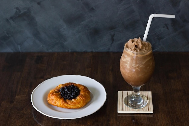 Coffee shake and blueberry baked pastry cake. Sweet dessert menu from cafe